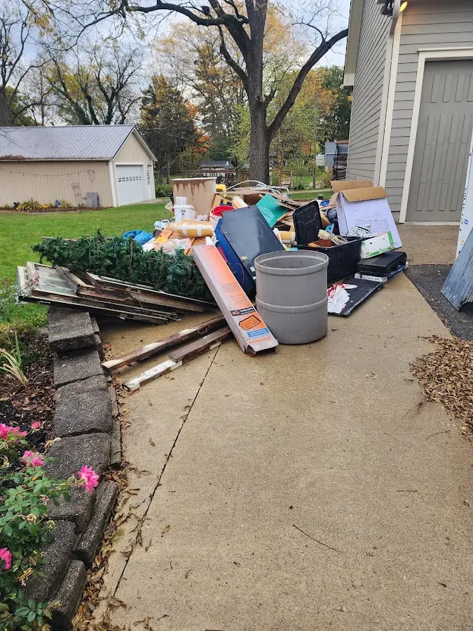 Dumpster being loaded with debris for Roofing Dumpster Rental in Merrimack